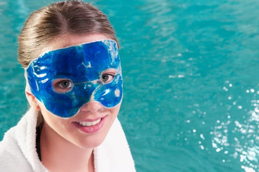 Woman wearing a mask at the poolside