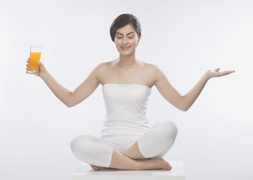 Woman holding a glass of orange juice