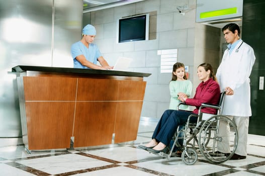Doctor pushing a woman in a wheelchair
