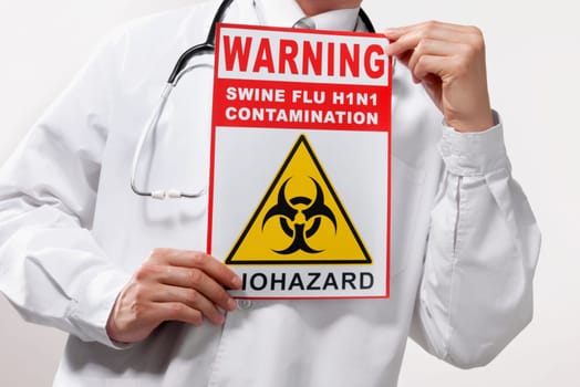 Doctor showing a Biohazard warning sign