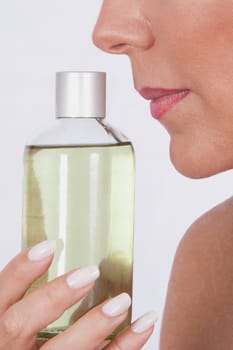 Woman smelling aromatherapy oil