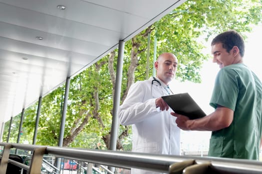 Doctor talking to a male nurse