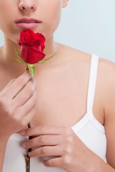 Close_up of a woman smelling a rose