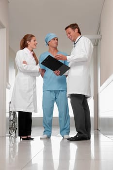 Three doctors discussing in a hospital