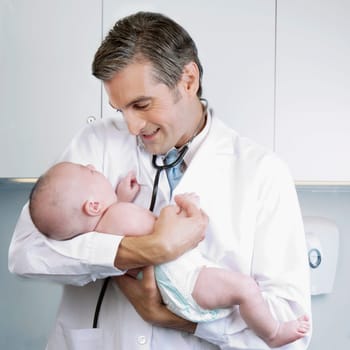Doctor carrying a newborn baby