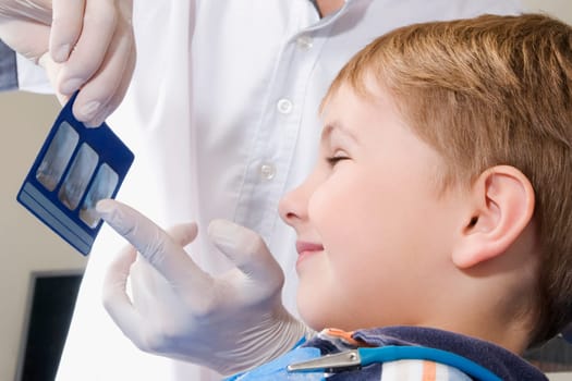 Dentist showing an X_Ray report to a boy