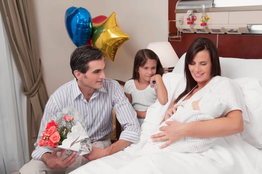 Couple with their newborn baby in a hospital