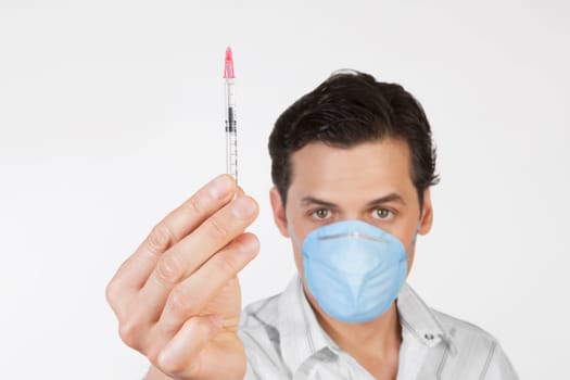 Portrait of a man showing a syringe