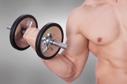 Mid section view of a man exercising with a dumbbell