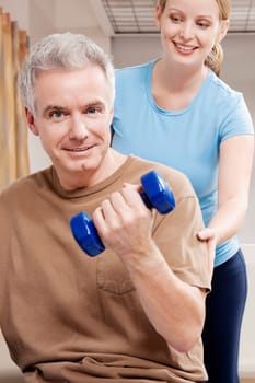 Physiotherapist assisting a patient in exercising