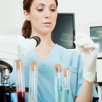 Female lab technician analyzing a sample in a laboratory