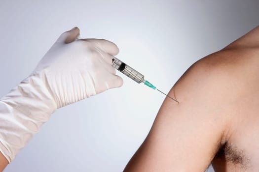 Doctor giving injection to a patient