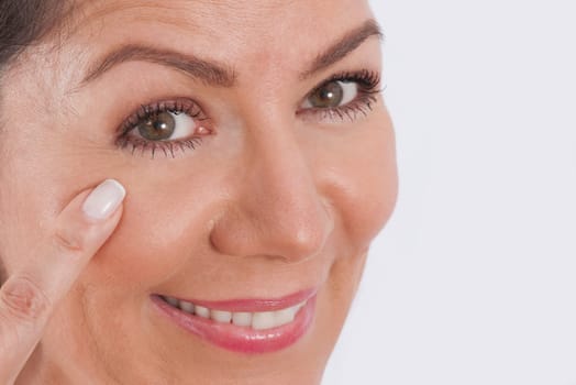 Close_up of a woman examining her face