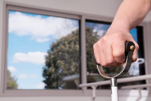 Human hand holding a crutch