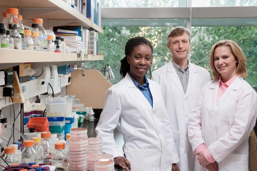 Portrait of three doctors smiling in a laboratory