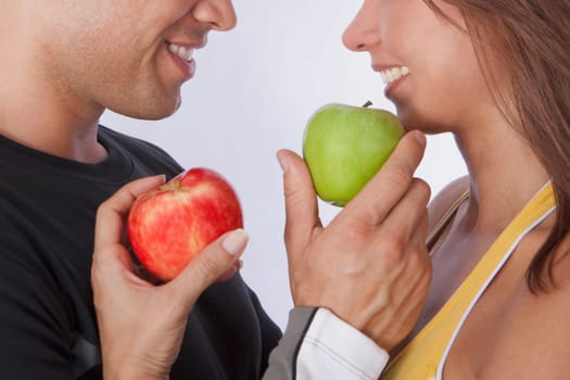 Couple offering apples to each other and smiling