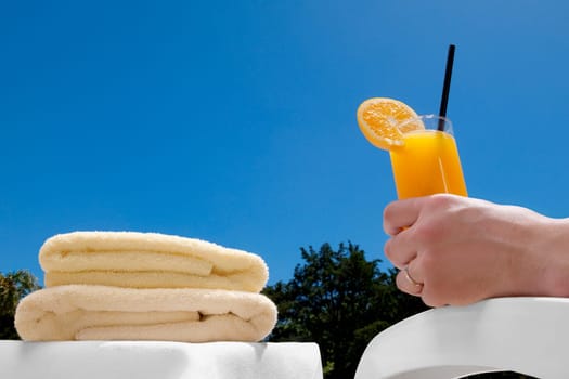 PersonŽs hand holding a glass of orange juice