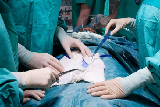 Surgeons performing a surgery in an operating room