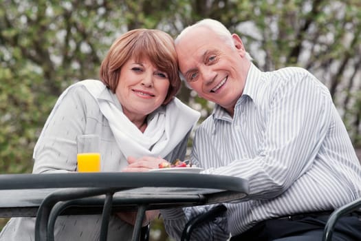 Couple sitting at a table and smiling