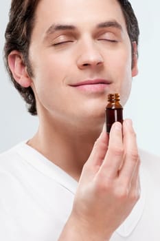 Man smelling aromatherapy oil