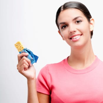 Portrait of a woman holding a protein bar