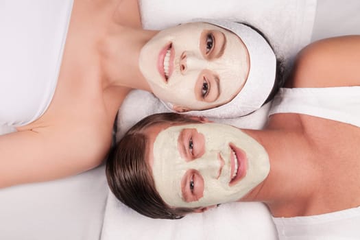 Couple with face pack on their faces