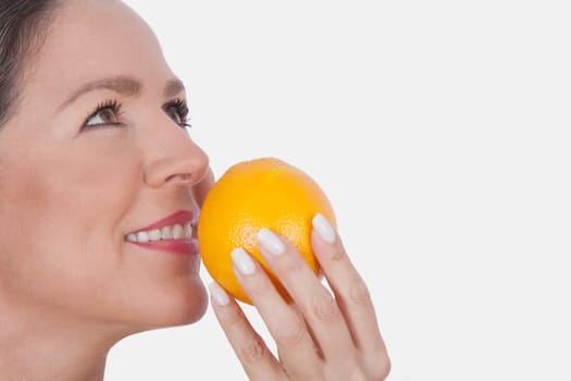 Woman smelling an orange
