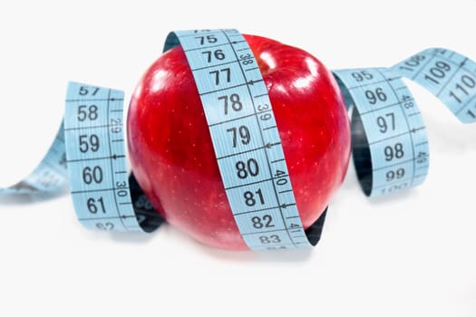 Apple wrapped in a tape measure