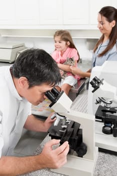 Vet looking into a microscope