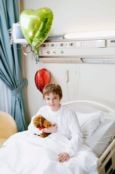 Portrait of a boy sitting on a hospital bed