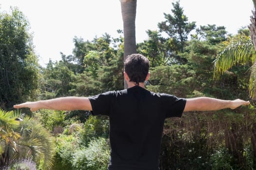 Man practicing yoga in a park