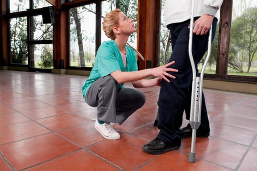 Physiotherapist assisting a woman in walking