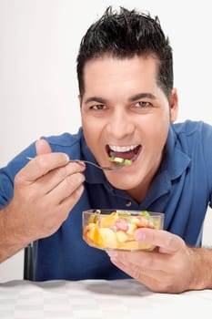 Portrait of a man eating fruit salad