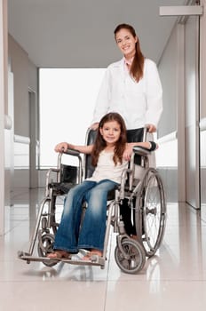 Female doctor pushing a patient in a wheelchair