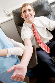 Doctor taking blood sample of a man