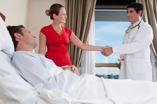 Woman shaking hand with a doctor
