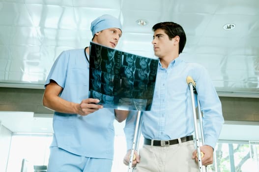 Male surgeon showing an X_Ray to a patient