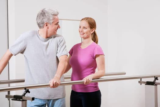 Physiotherapist assisting a patient in walking