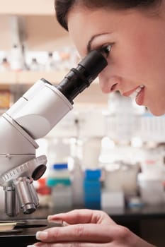 Female doctor working on a microscope in a laboratory