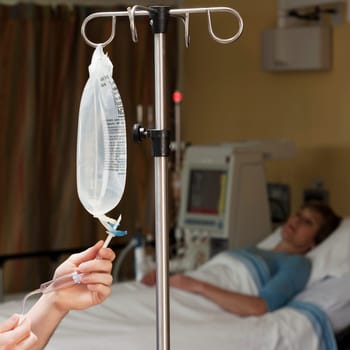 Female doctor checking a saline drip