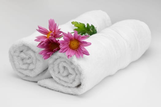 Close_up of rolled up towels with flowers