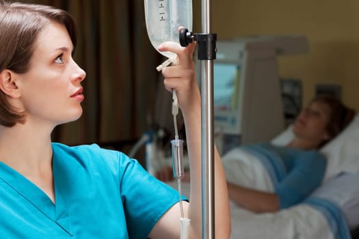 Female doctor checking a saline drip