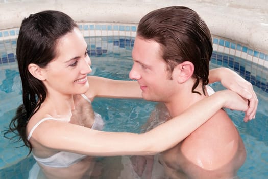Couple romancing in a hot tub