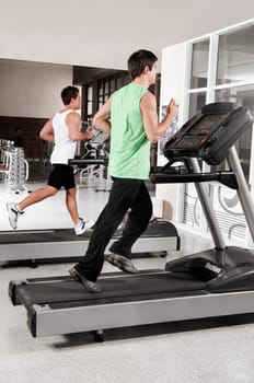 Two men running on treadmills