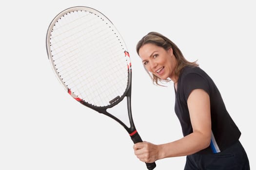 Woman holding a tennis racket and smiling