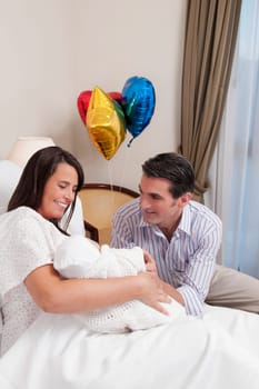 Couple with their newborn baby in a hospital