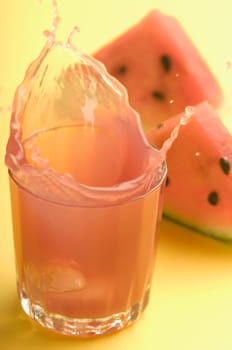 Close_up of watermelon with a glass of watermelon juice