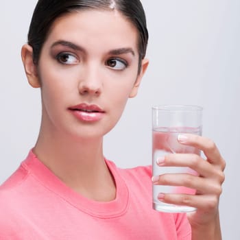 Close_up of a woman holding a glass of water