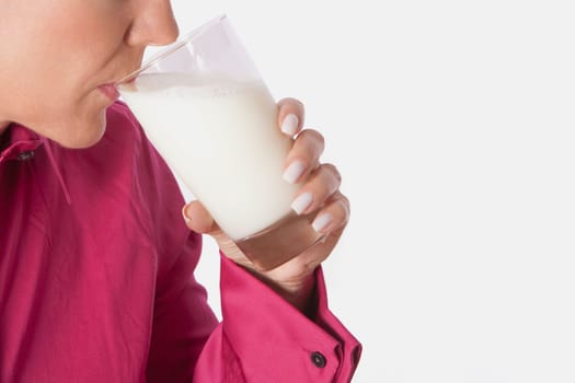 Close_up of a woman drinking milk from a glass