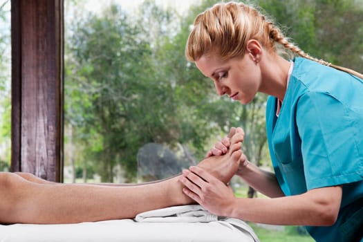 Physiotherapist massaging a personŽs foot